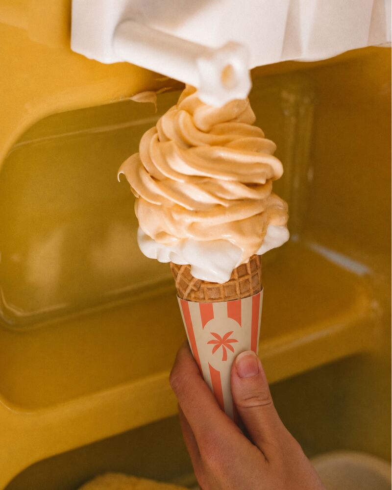 Soft serve poured into a striped cone